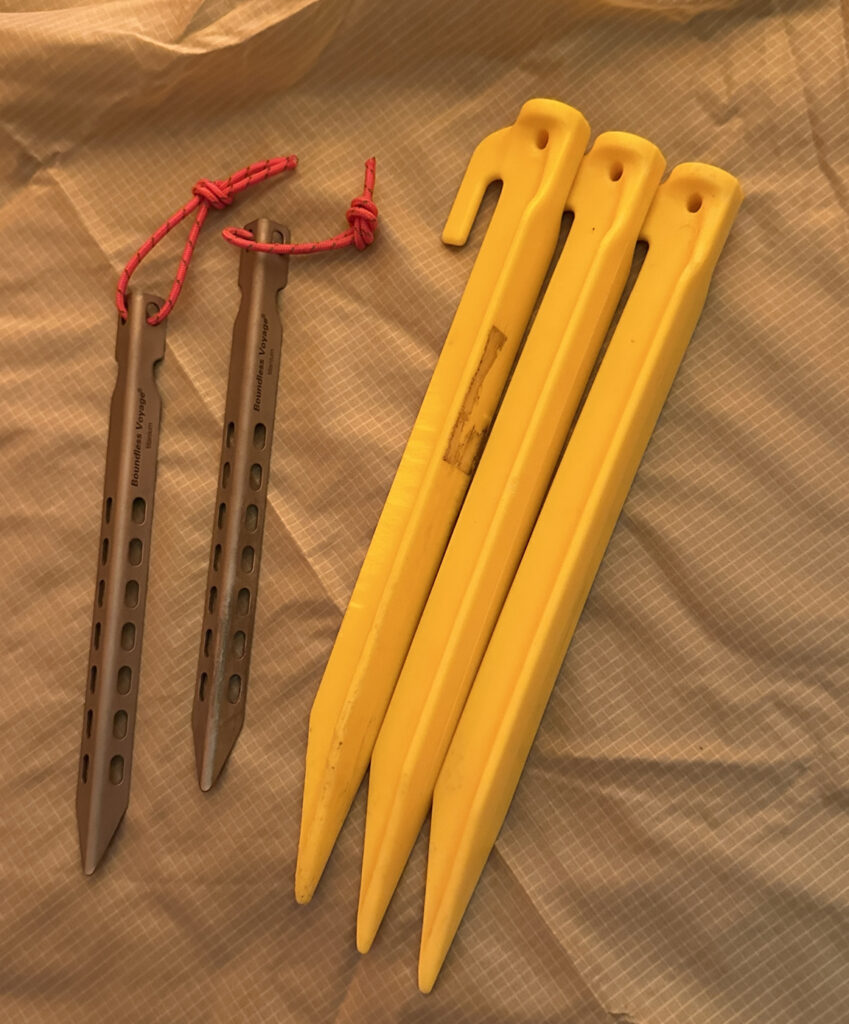 Plastic Coghlan tent pegs and titanium tent pegs